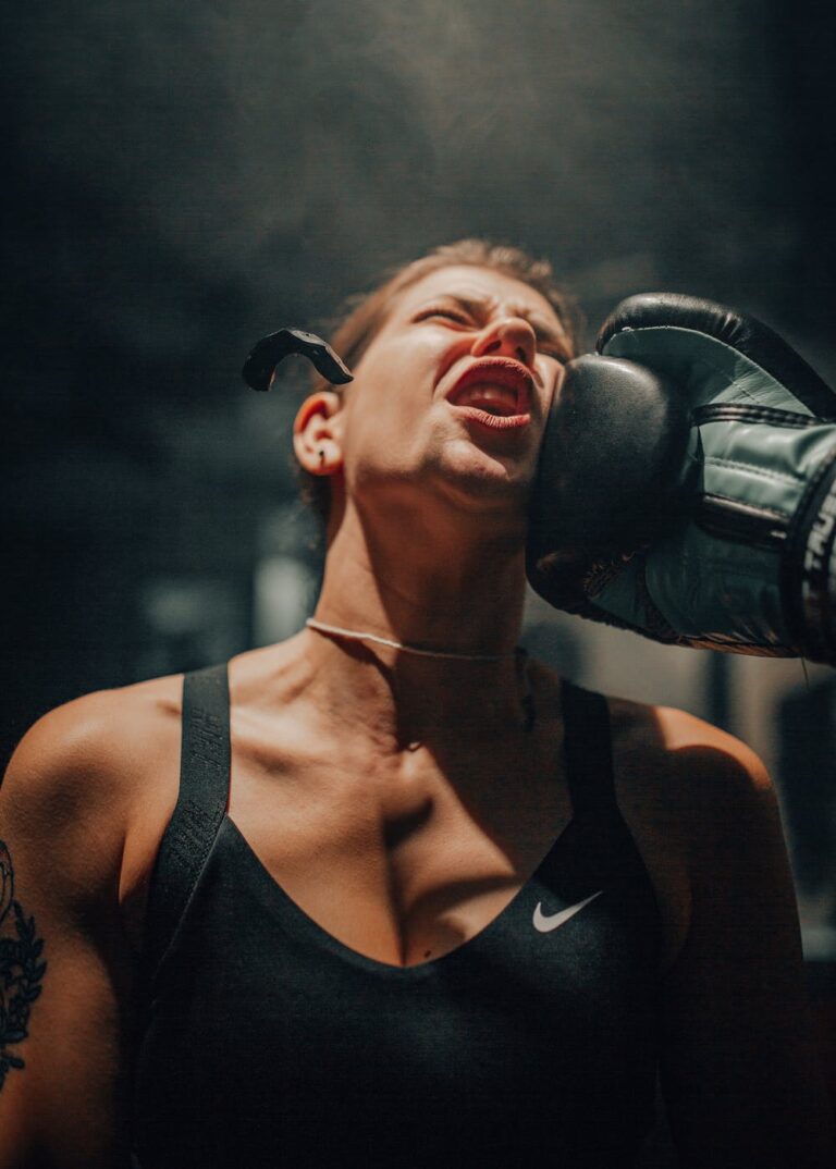 Female boxer getting hit with a hook.