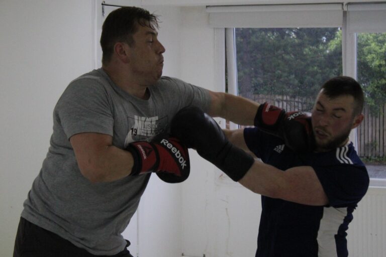 boxer landing a hit to head on the opponent