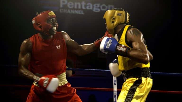 Two amateur boxers boxing in a ring.