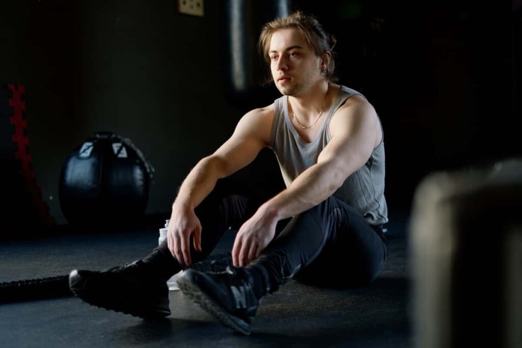 A man resting during a workout.