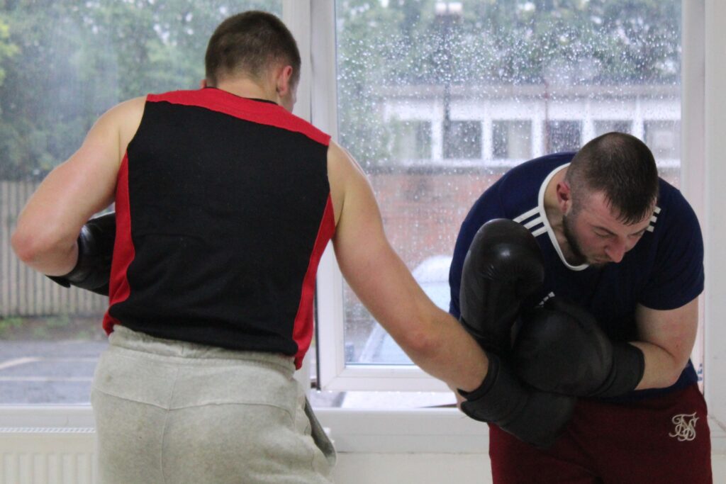 Boxer Mike throwing punches to the opponent's body