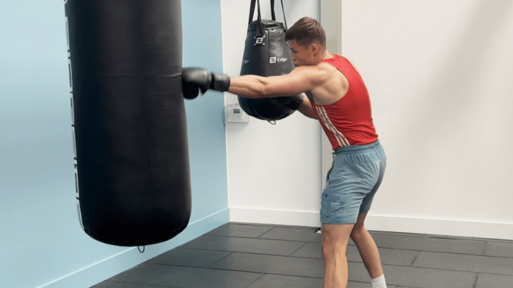 A boxer working on the heavy bag.