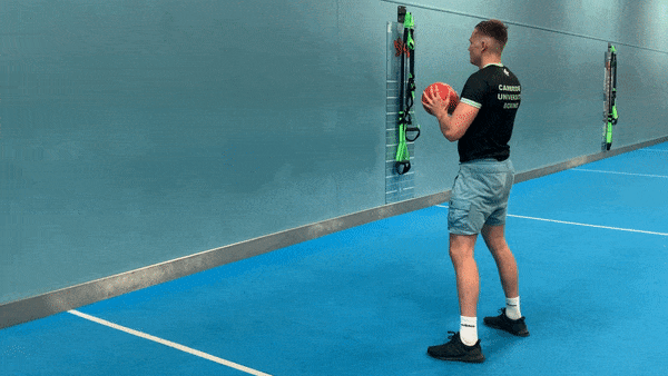 A demonstration of the medicine ball chest pass against a wall